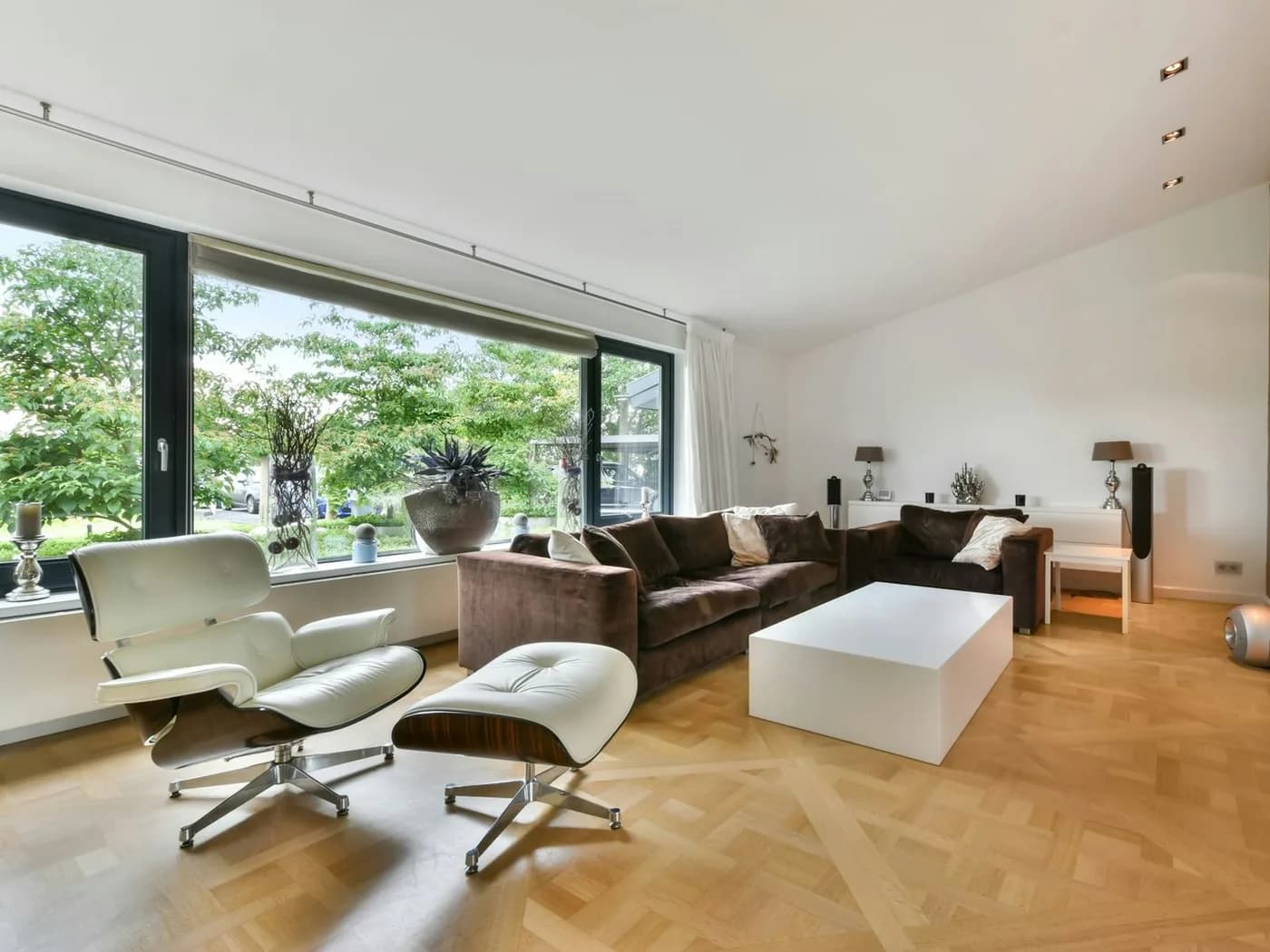 A bright, modern living room with floor-to-ceiling windows