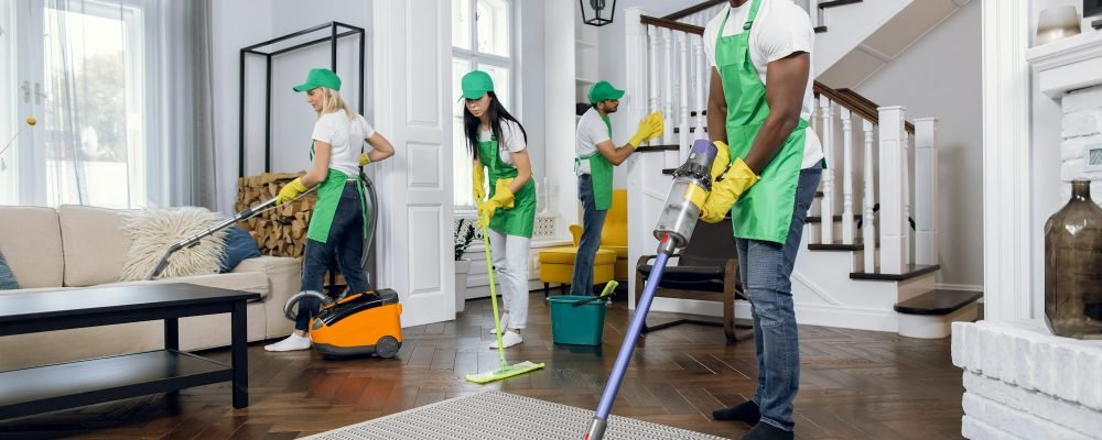 Group of four multiracial people cleaning client house