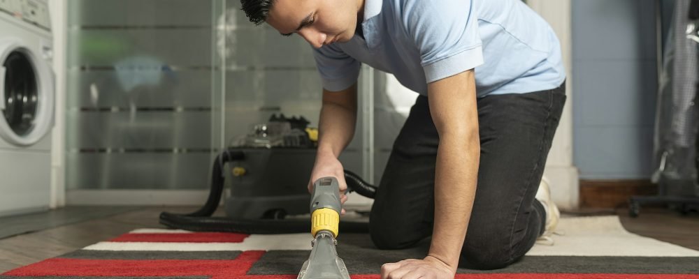 Laundry worker cleaning carpet with special equipment