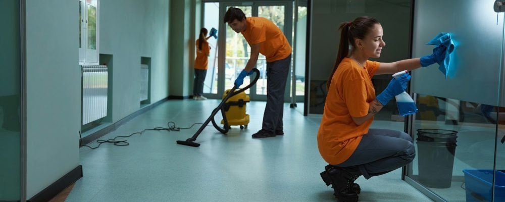 Team of certified janitors doing their best to clean building